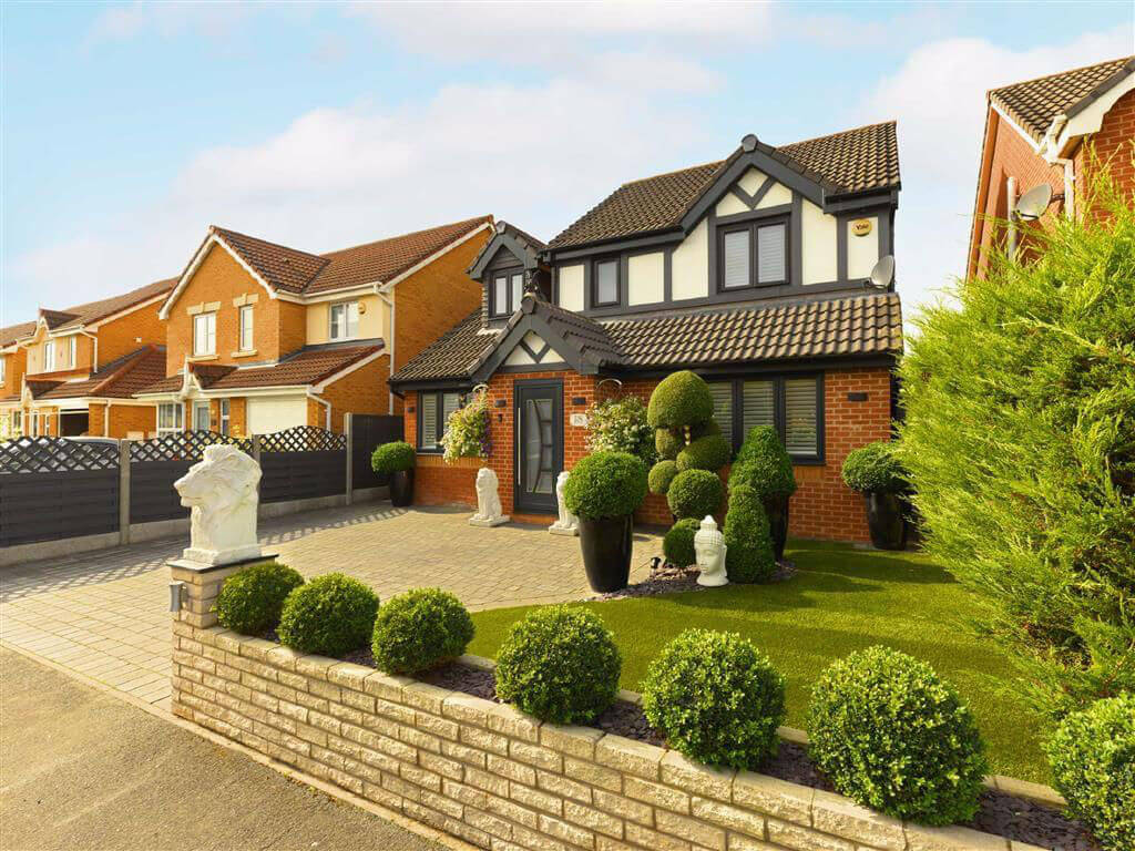Modern detached house exterior featuring black uPVC windows